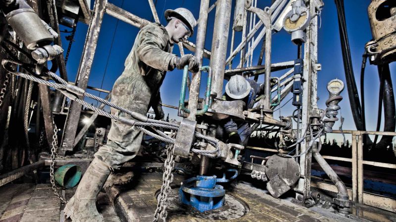 Alberta, Canada: Oil workers using oil drill.