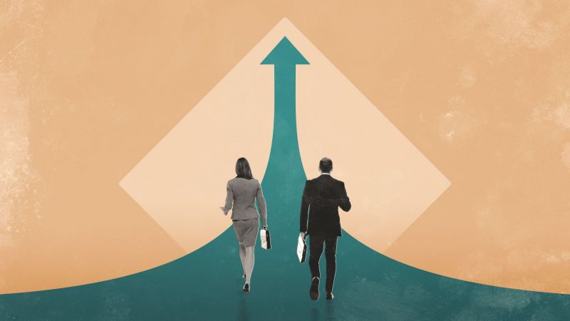 Businesswoman and businessman walking towards arrow pointing up