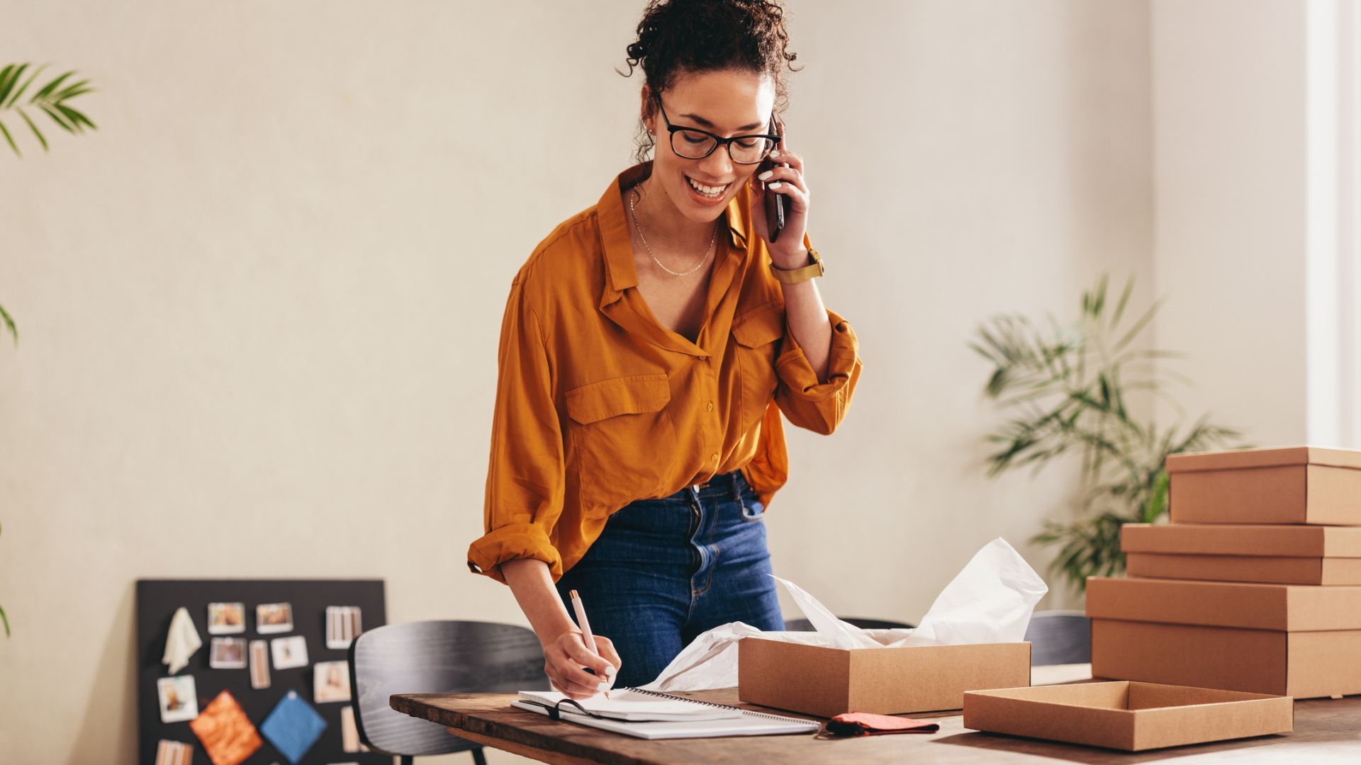 Female entrepreneur talking on mobile in home office