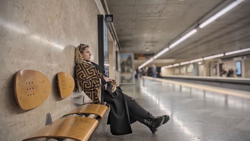Woman waiting for a commuting metro train at a subway station in Lisbon, Portugal