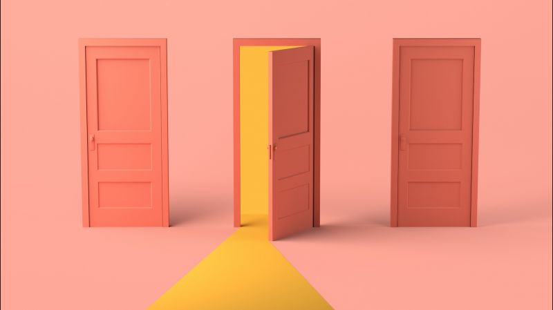 Three doors on pink background with door in the middle slightly open