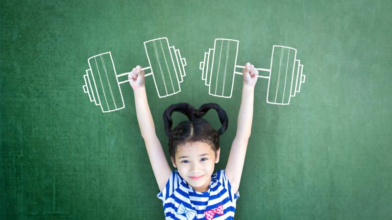 Healthy, strong girl with dumbbell exercise doodle on school chalkboard.