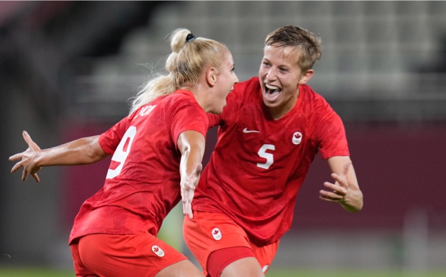 Adriana Leon (left) and Quinn celebrate at the Tokyo 2020 Olympic Games.