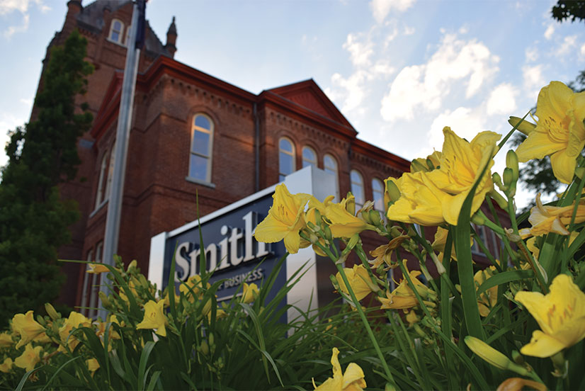 Goodes Hall with yellow lilies in the foreground 