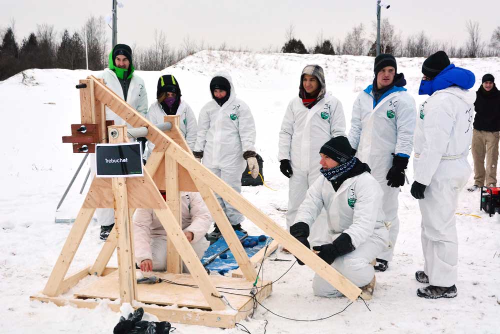 A Smith MBA team tackles the trebuchet challenge, an exercise in operating a replica of a siege engine used in the Middle Ages. 