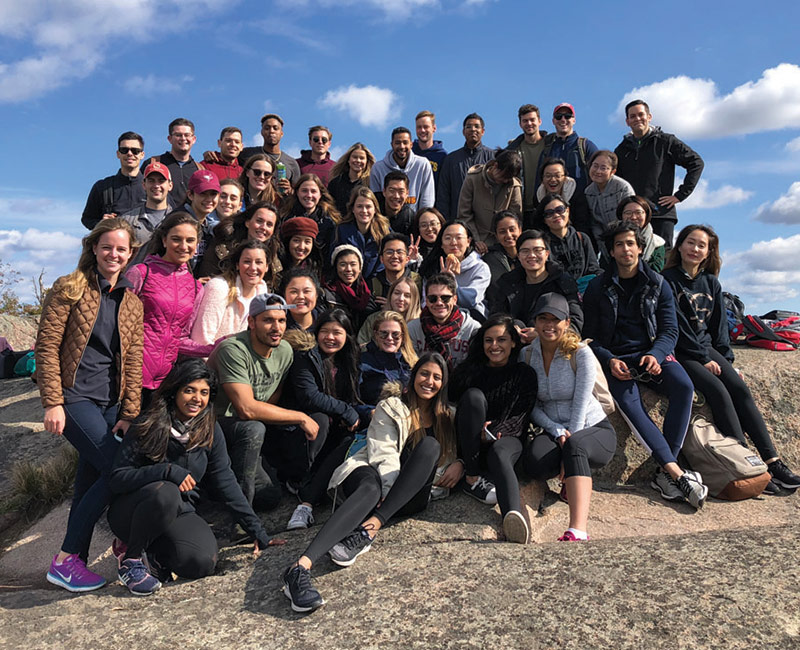 A recent MIB class enjoy a break during a hike