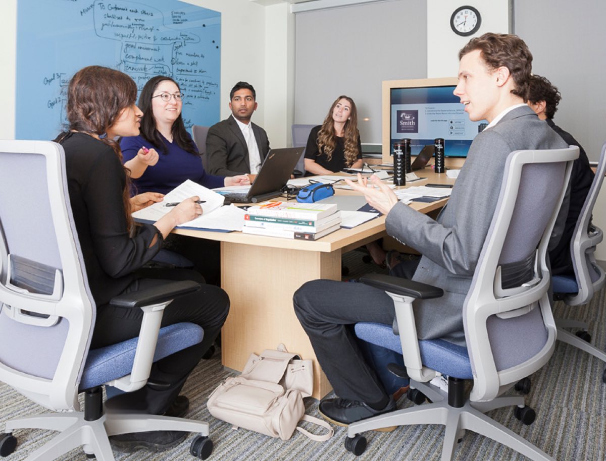 Students in a boardroom in Goodes Hall